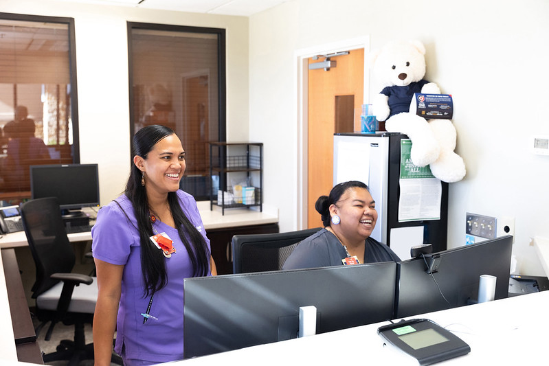 WIC clinic staff smiling at the front desk.