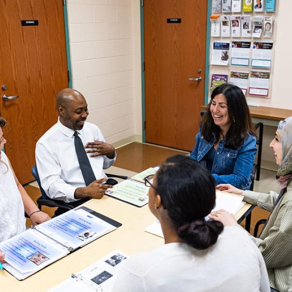 WIC clinic staff members enjoy a lively discussion while reviewing clinic guidance during an internal training workshop.